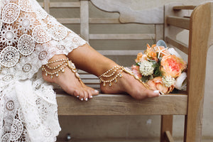 gold foot jewelry on a bride